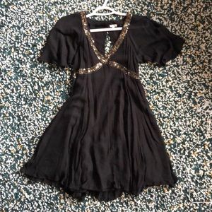 Em Creme black dress with sequence details